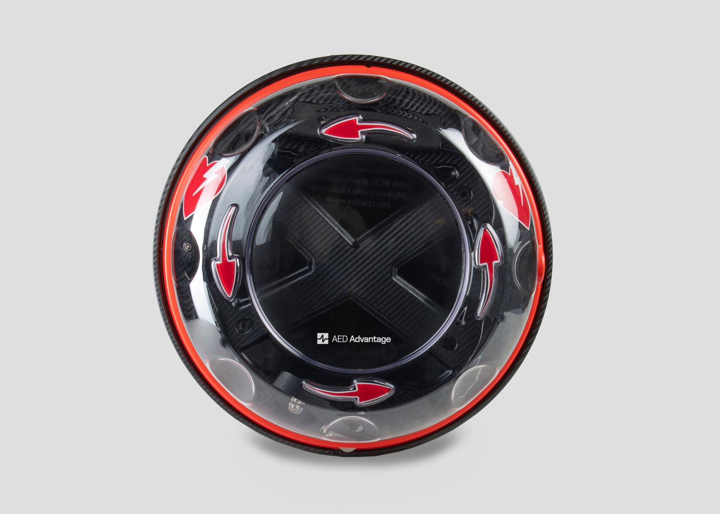 A black and yellow, spherical defibrillator cabinet with red arrows indicating which way to turn the lid to open it