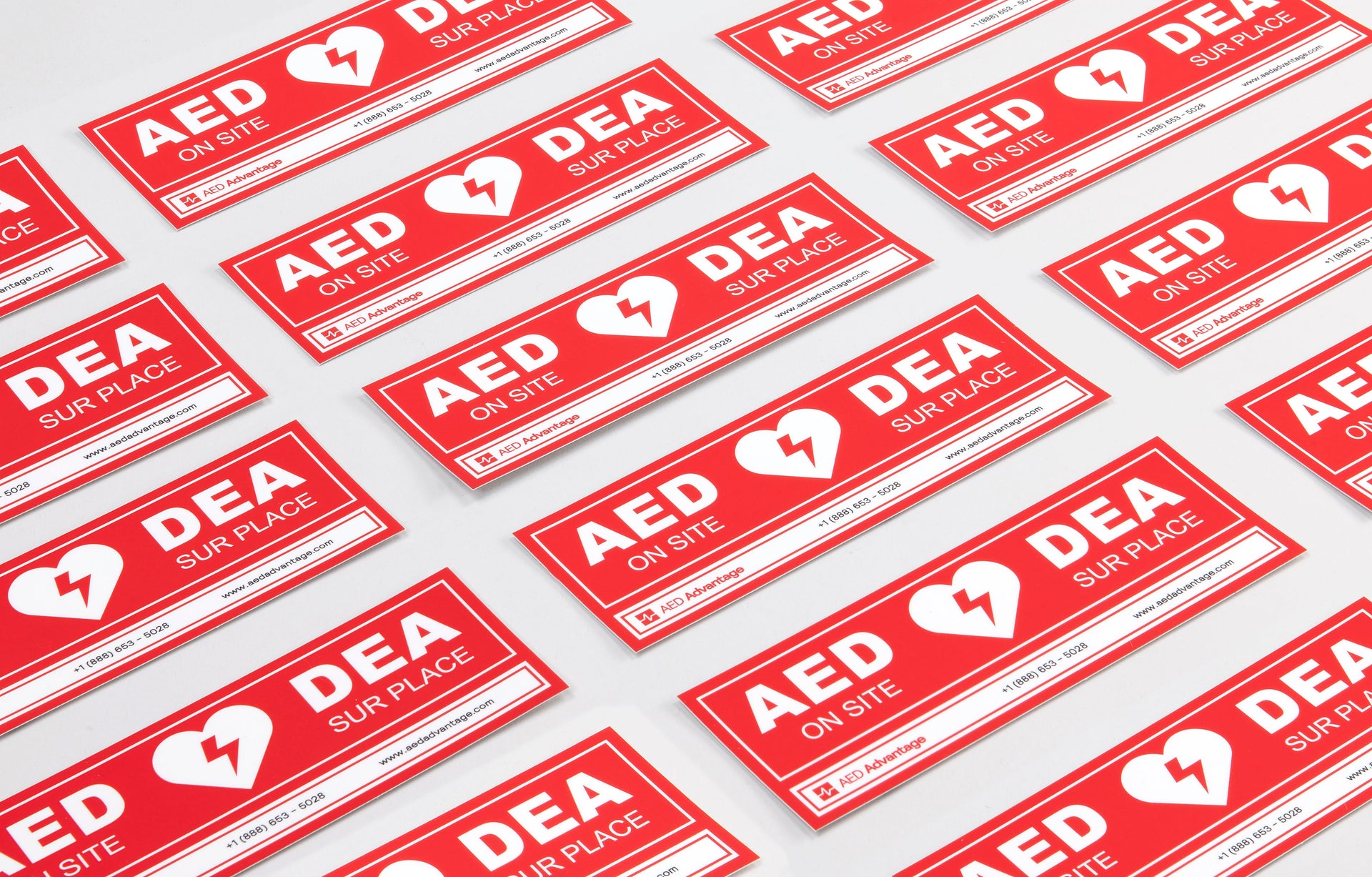 A collage of red rectangular decals that adhere to doors indicating an AED is present at a facility
