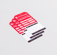 Three red and white tags meant for tracking defibrillator inspections