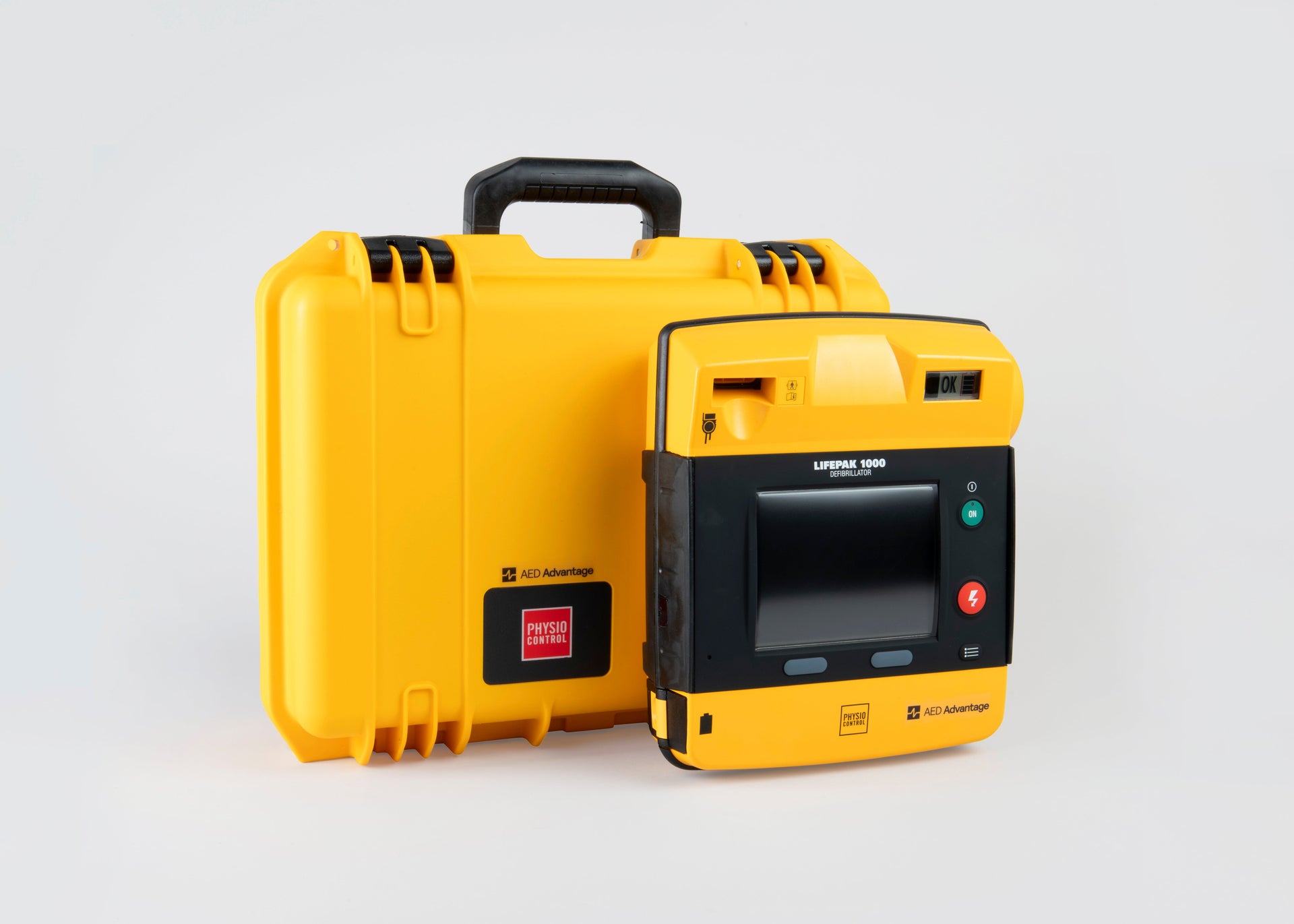 A bright yellow hardshell AED case with a black and yellow LIFEPAK 1000 AED standing in front.