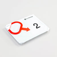 A white rectangular electrode cartridge for the LIFEPAK CR2 defibrillator with a red tab on its top left corner