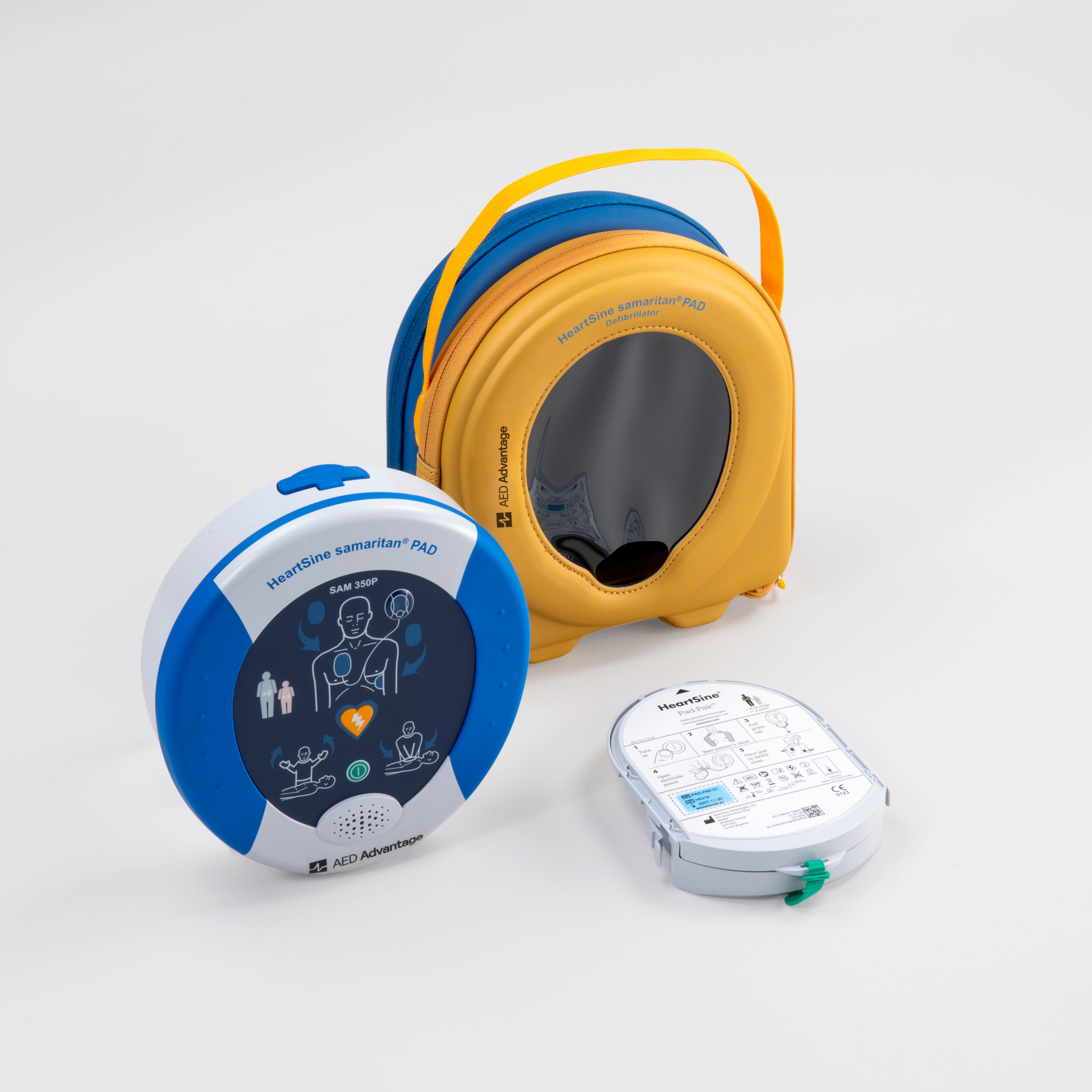 A blue and gray HeartSine 350P AED standing next to its yellow softshell carry case