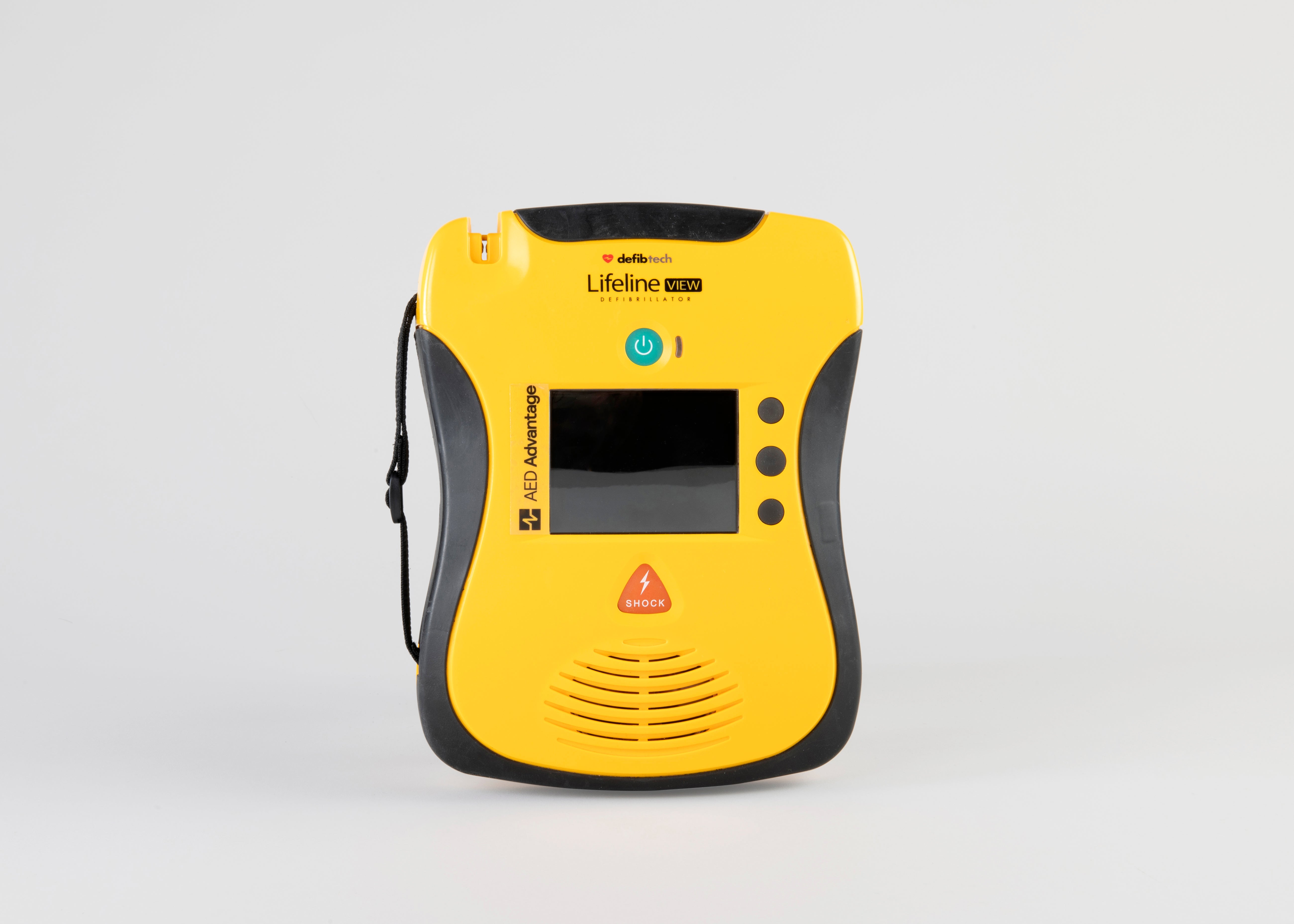 A black and yellow Defibtech Lifeline VIEW AED displayed head on with its battery pack and electrodes.