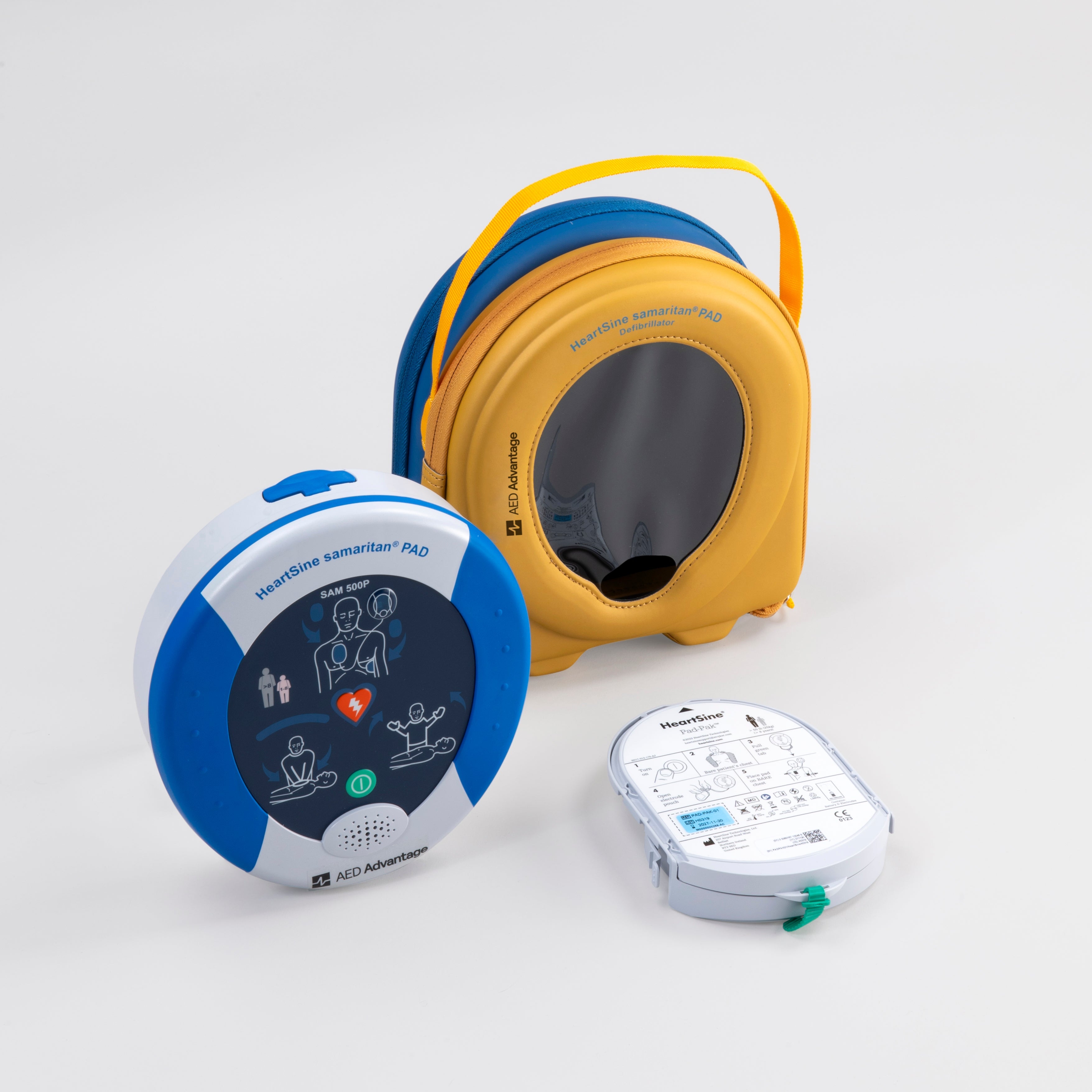 A blue and gray HeartSine 500P AED with its yellow carry case and pads cartridge